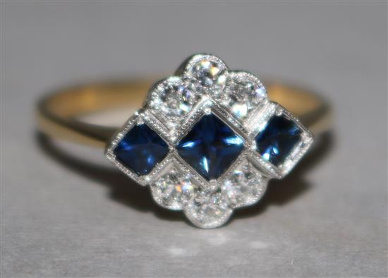 An Art Deco style 18ct gold, sapphire and diamond cluster ring, size P.